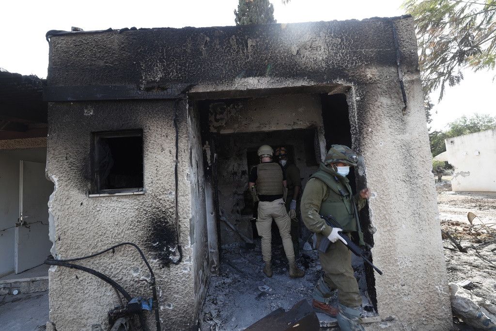 Israelische Soldaten betreten ein abgebranntes Haus im Kibbuz Kfar Aza nahe des Gazastreifens.